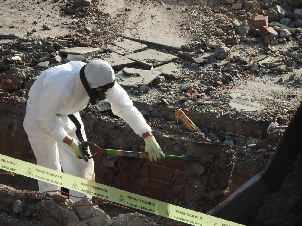 Worker,with,white,protective,suit,,gloves,and,mask,removes,removal